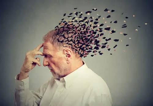 Older man holding his head with visual fragments breaking away